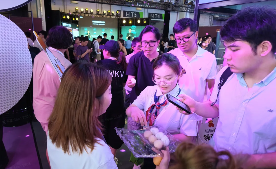 Attendees receive egg-shaped stress toys at the Trooly booth.
